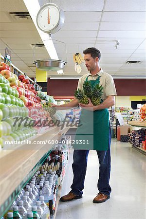 Sales Associate Stocking Shelves in Grocery Store