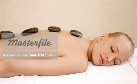 Young woman enjoying a hot  stone massage