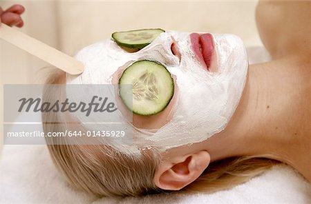 Woman having a facial treatment in a spa