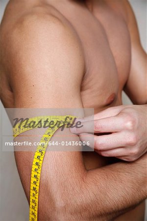 Man measuring his arm muscle