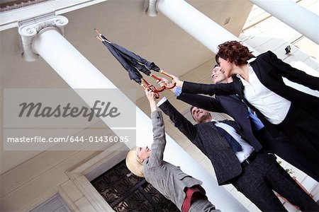 Business people reaching for the sky
