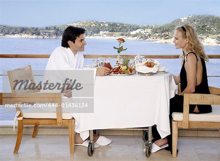 Couple having breakfast on hotel terrace
