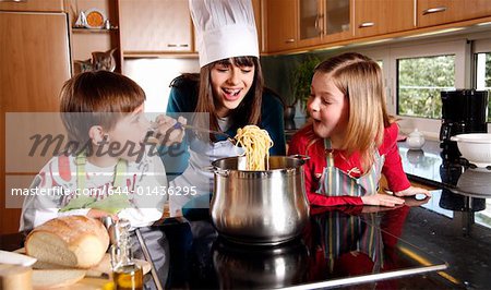 Children cooking spaghetti