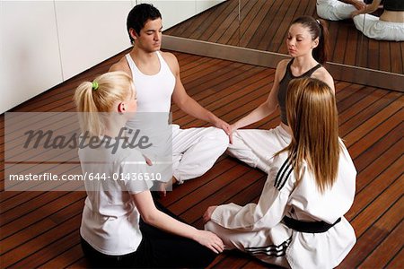 Participants in a fitness class meditating