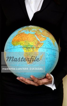 A woman holding a globe