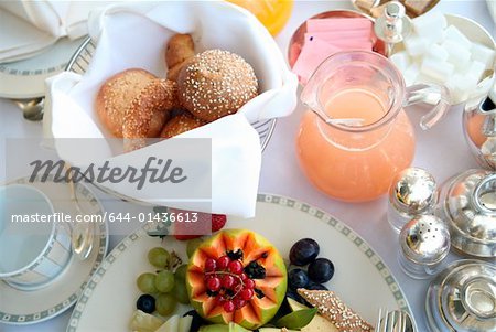 Breakfast table with fruit, breads, juices