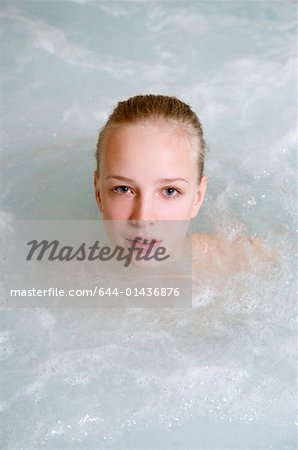 Young woman in jacuzzi at a spa