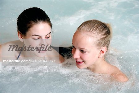 Two young woman in jacuzzi at a spa