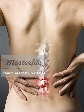 Rear view of woman with hands on back and sore spine