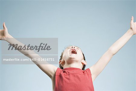 Boy with arms upstretched and mouth open