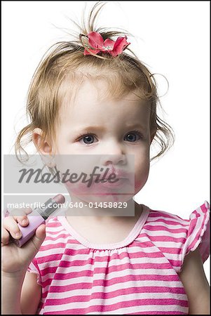 Girl with tube of lipstick and lipstick on face