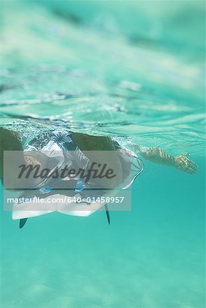 Man in water with surfboard