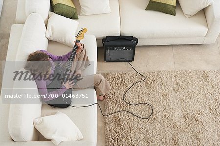 Girl Playing Guitar on Sofa