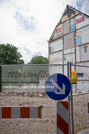 Sign on Fence Outside Old Building