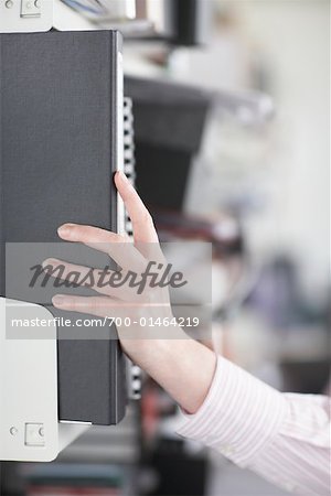 Businesswoman Reaching for File Folders