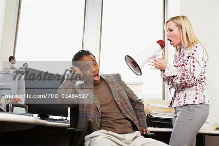 Woman Using Megaphone to Talk to Man