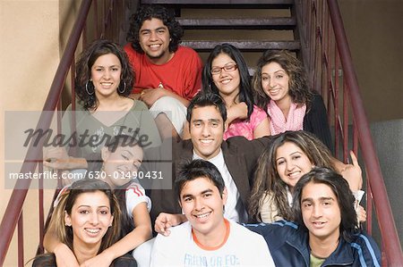 Portrait of a group of college students sitting on a staircase