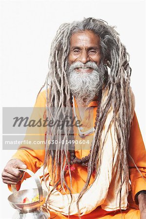 Portrait of a sadhu holding a kamandal and smiling