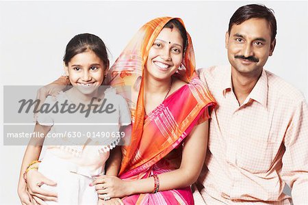 Portrait of a couple sitting with their daughter