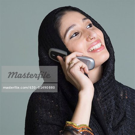 Close-up of a young woman talking on a mobile phone and smiling