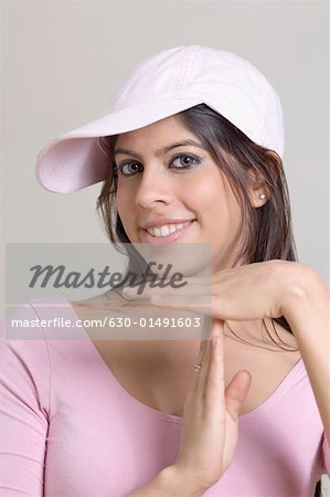 Portrait of a young woman showing a time out sign