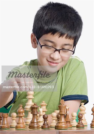 Close-up of a boy playing chess