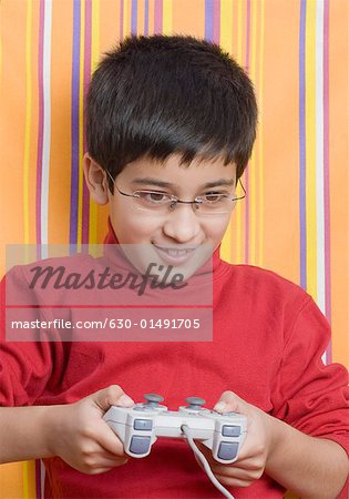 Close-up of a boy playing video game