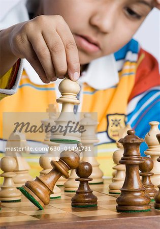 Close-up of a boy playing chess