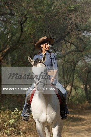 Young woman riding a horse