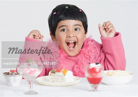 Portrait of a girl shouting at a dining table