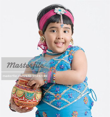 Portrait of a girl holding a decorated earthenware pot