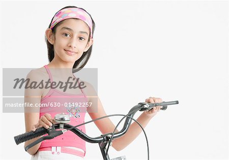 Portrait of a girl holding the handlebar of a bicycle
