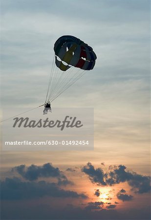 Silhouette of a person parasailing in the sky, Calangute Beach, Goa, India