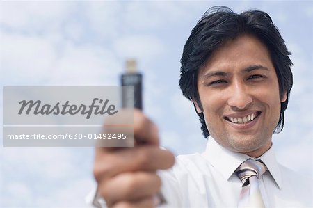 Portrait of a businessman holding a USB pen drive