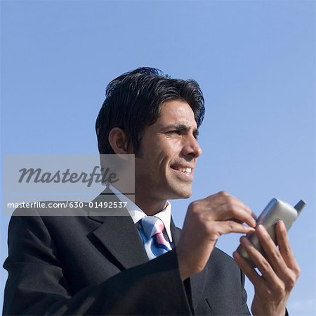 Close-up of a businessman using a personal data assistant