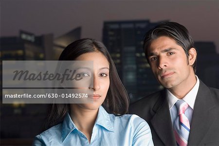 Portrait of a businesswoman with a businessman thinking