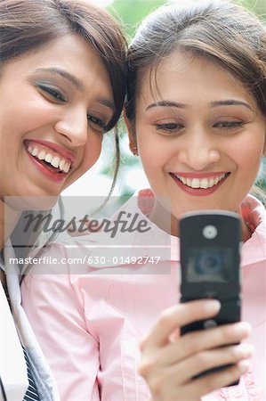 Deux femmes d'affaires en regardant un téléphone mobile