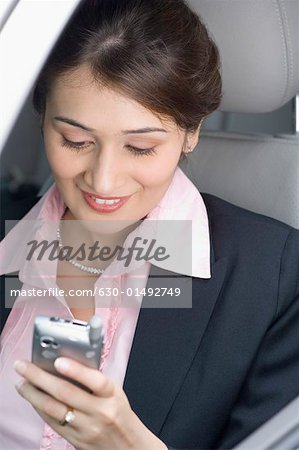 Businesswoman operating a mobile phone