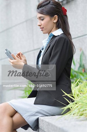 Businesswoman using a personal data assistant