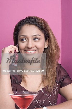 Close-up of a young woman talking on a mobile phone and smiling