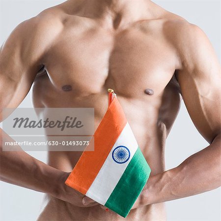 Mid section view of a young man holding an Indian flag