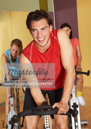 Group of People Using Exercise Bicycles