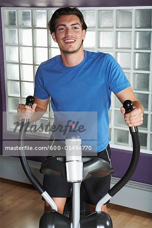 Man Using Elliptical Trainer