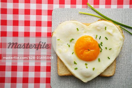 Heart-shaped fried egg on toast