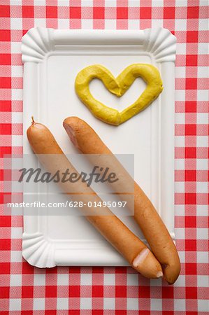 Two wieners with heart-shaped mustard