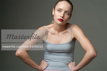 Agile woman with arms akimbo