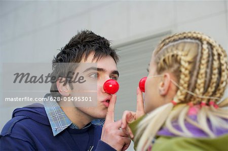 Young couple wearing red noses