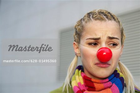 Cheerless young woman with red nose
