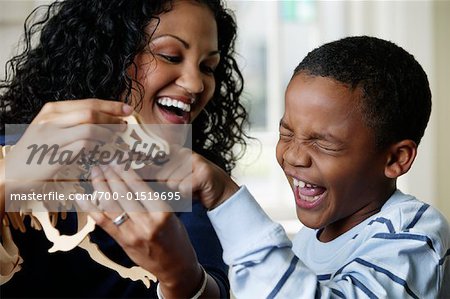 Mother and Son Playing with Dinosaur Toy