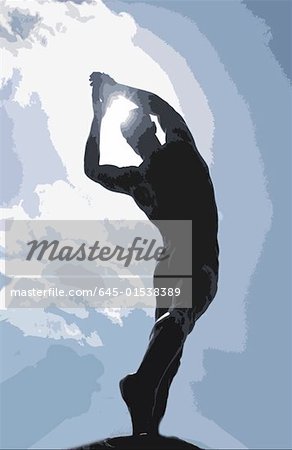 Silhouette of man just having thrown a discus